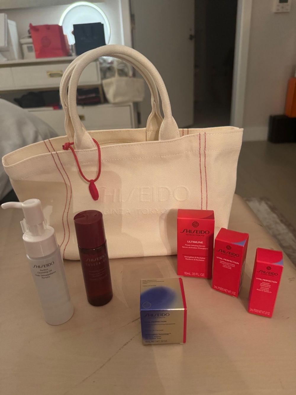 Shiseido cream canvas tote with red-accent skincare set